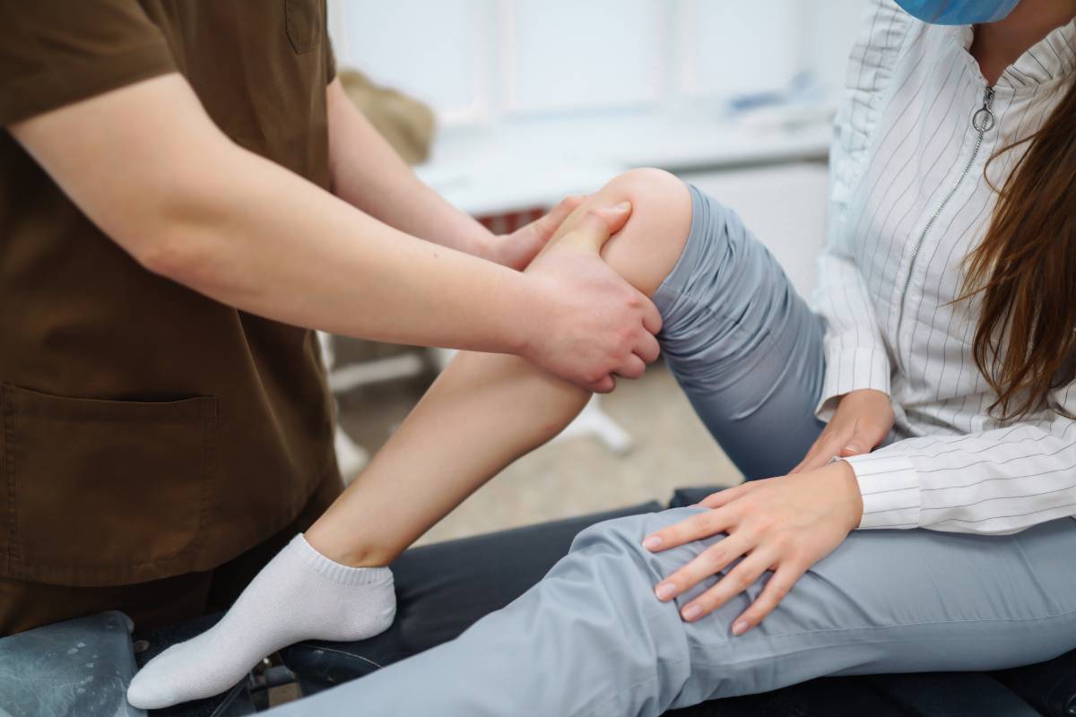 doctor-examining-female-patient-with-injured-leg-2024-02-07-18-14-54-utc (1)