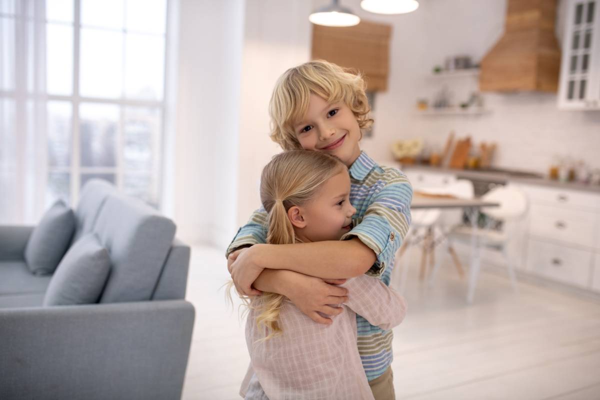 Boy and girl smiling and embracing each other