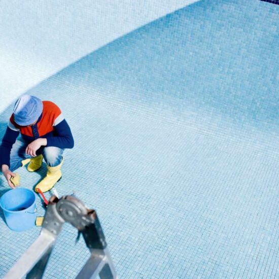 Man cleaning tiled pool